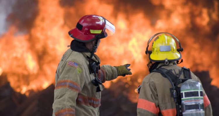 two firemen next to fire