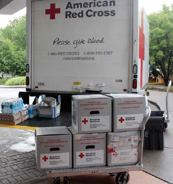 Red Cross boxes next to truck