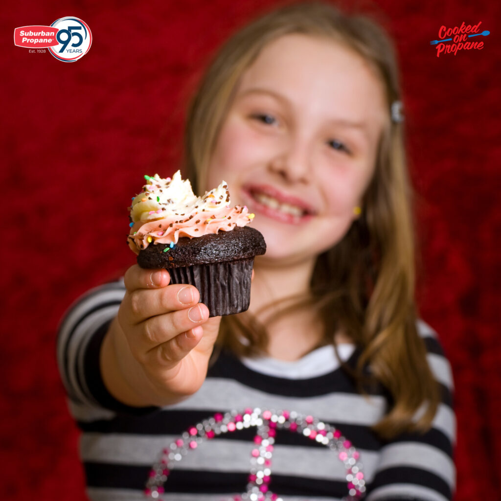 child sharing a cupcake