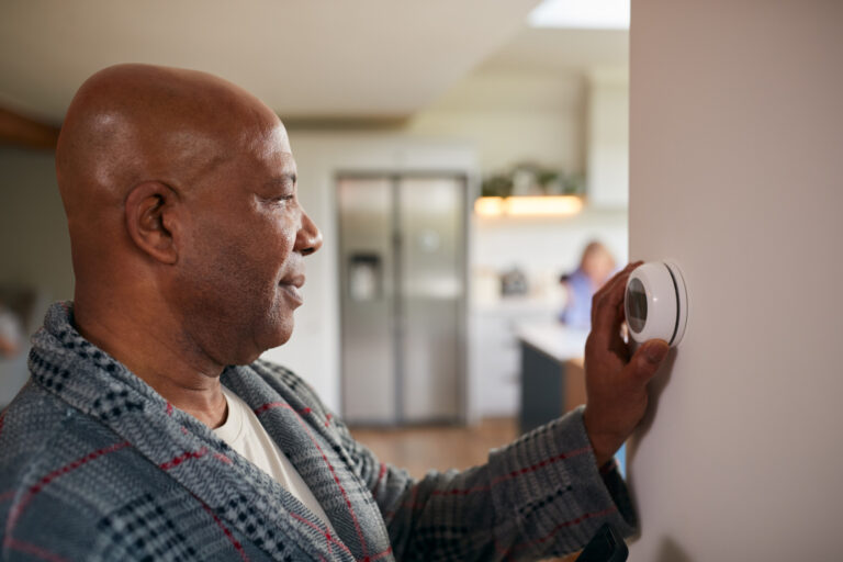 man controlling the thermostat