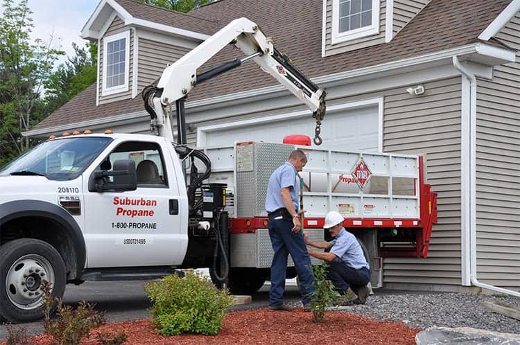 Suburban Propane service workers by truck