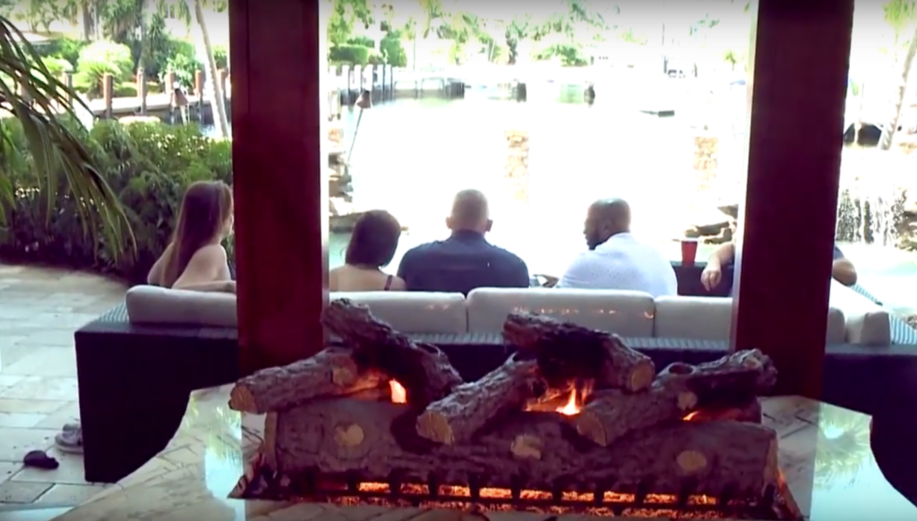people sitting on couch in front of fire place