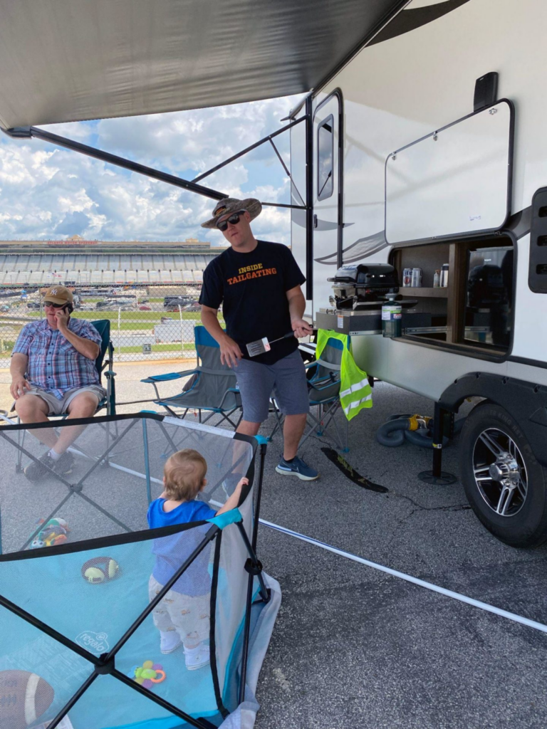 Man standing outside of RV camper at NASCAR