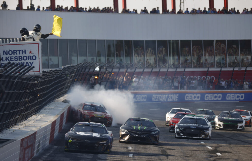 NORTH WILKESBORO, NORTH CAROLINA - MAY 21: Michael McDowell, driver of the #34 Fr8Auctions Ford, spins into the wall after an on-track incident as Ty Gibbs, driver of the #54 Monster Energy Toyota, Josh Berry, driver of the #48 Ally Chevrolet, and Aric Almirola, driver of the #10 Smithfield Ford, pass during the NASCAR Cup Series All-Star Open Race at North Wilkesboro Speedway on May 21, 2023 in North Wilkesboro, North Carolina. (Photo by Jared C. Tilton/Getty Images)