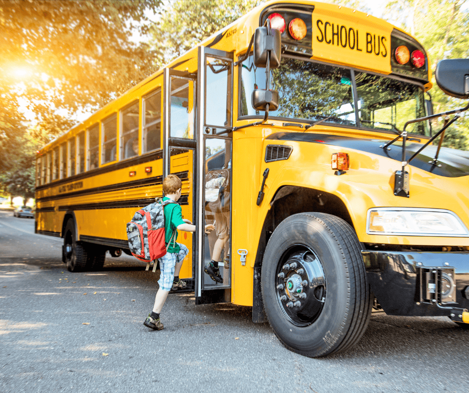 Kids getting on a school bus