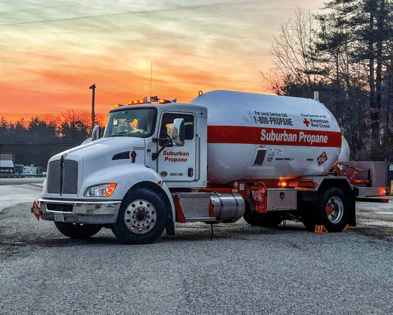 A Suburban Propane truck safely parked in a commercial parking lot.