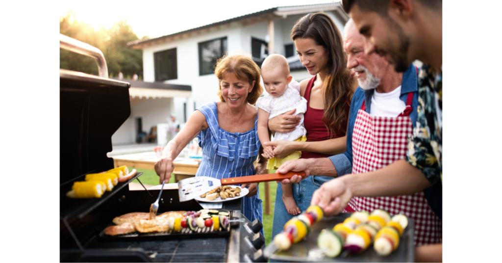 A family grills on a propane barbeque in their backyard