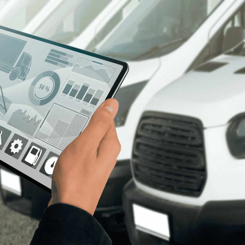person holding tablet in front of vans