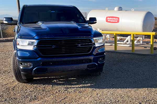 autogas pickup truck with a propane tank in the background