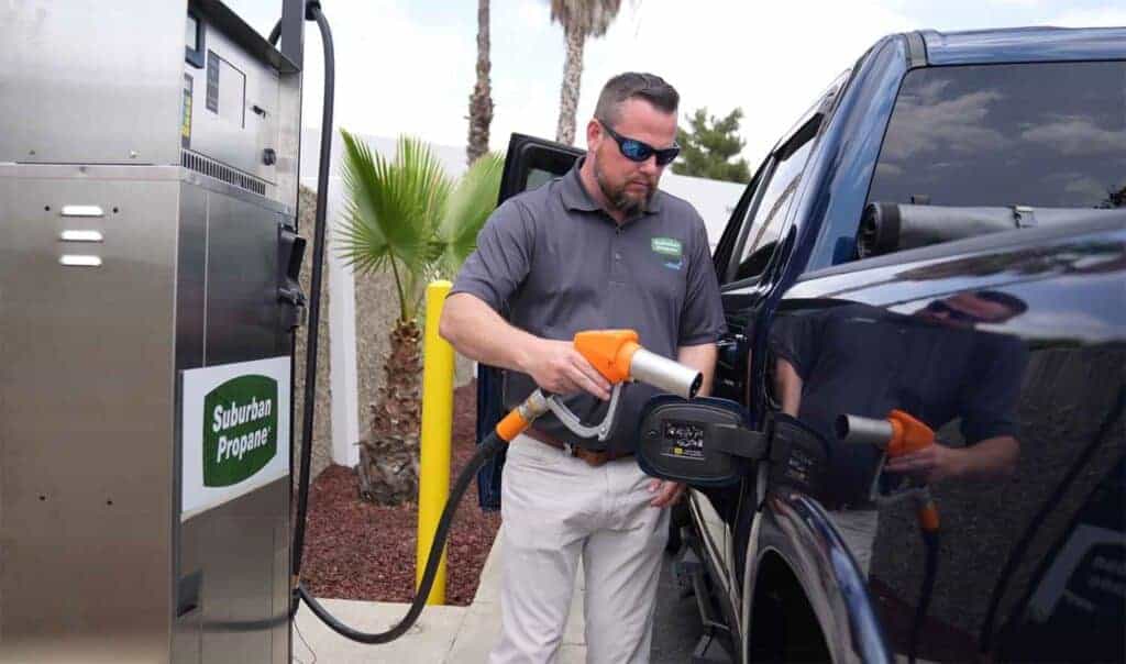 man fueling pickup truck with renewable propane