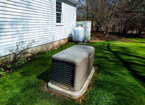Propane generator installed outside a home, on a green lawn