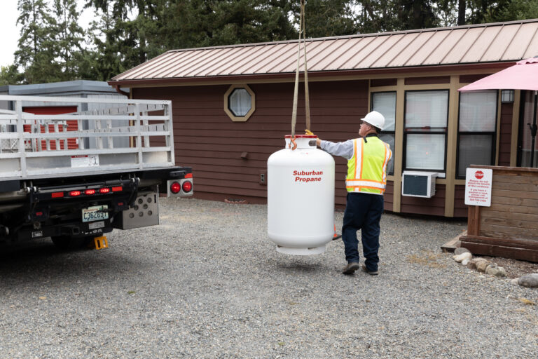 Suburban employee delivering propane