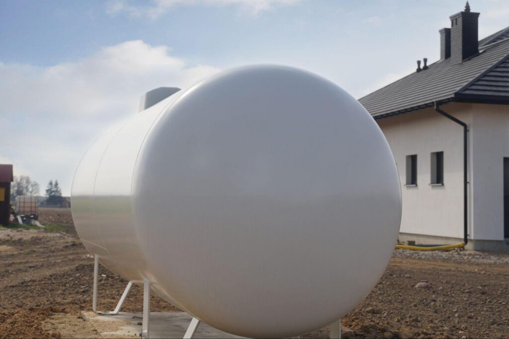 A propane tank located outside a suburban home