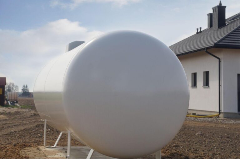 A propane tank located outside a suburban home
